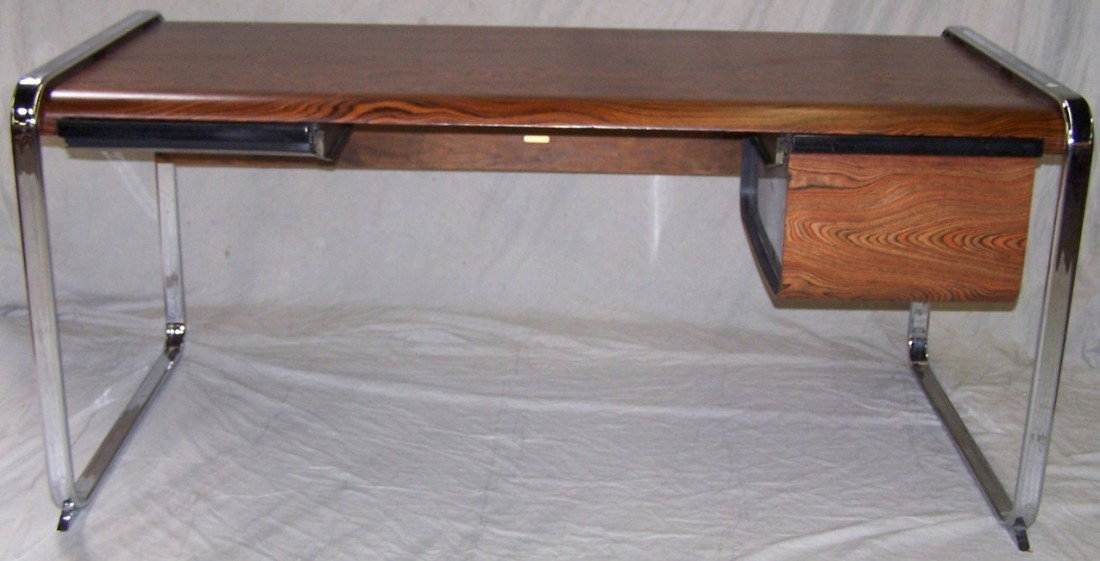 PETER PROTZMAN FOR HERMAN MILLER DESK: Having rosewood and chrome frame and fitted with 3 drawers, approximate height 29 3/4'', width 65'', depth 32''.