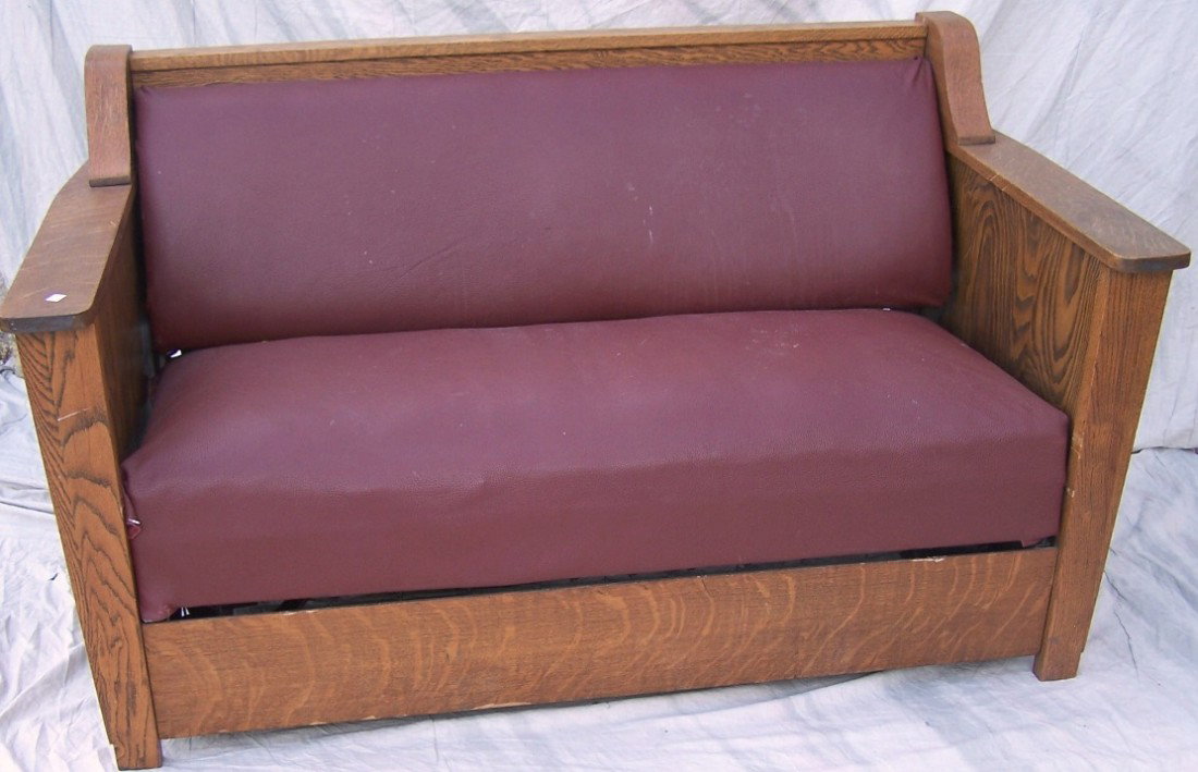 ***ARTS AND CRAFTS HIDE-A-BED: Having oak frame and brown upholstered back and seat, approximate height 36'', width 59 1/2'', depth 32''.