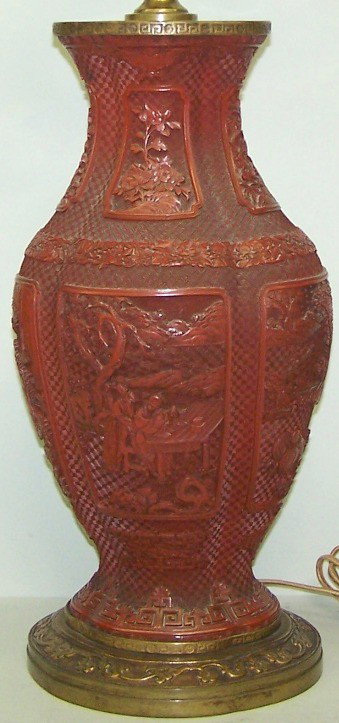***ORIENTAL CINNABAR VASE: ***ORIENTAL CINNABAR VASE| With relief decoration depicting figures and landscape, mounted as table lamp, approximate height of vase 17 3/4".