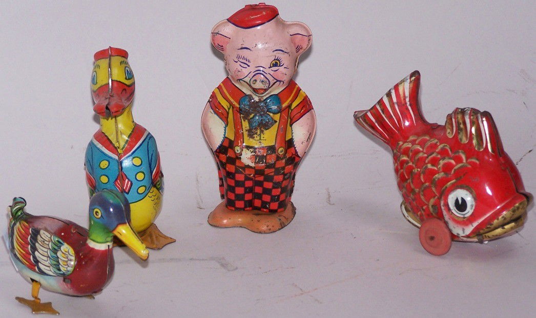***4 TIN LITHO WIND UP & FRICTION TOYS: Wind up duck by J. Chein, approximate height 4'', wind up pig by J. Chein, height 4 1/2'', wind up duck made in U.S. Zone Germany by D.R.G.M., height 2 1/2'', and friction motored fish by Lehmann D.G.