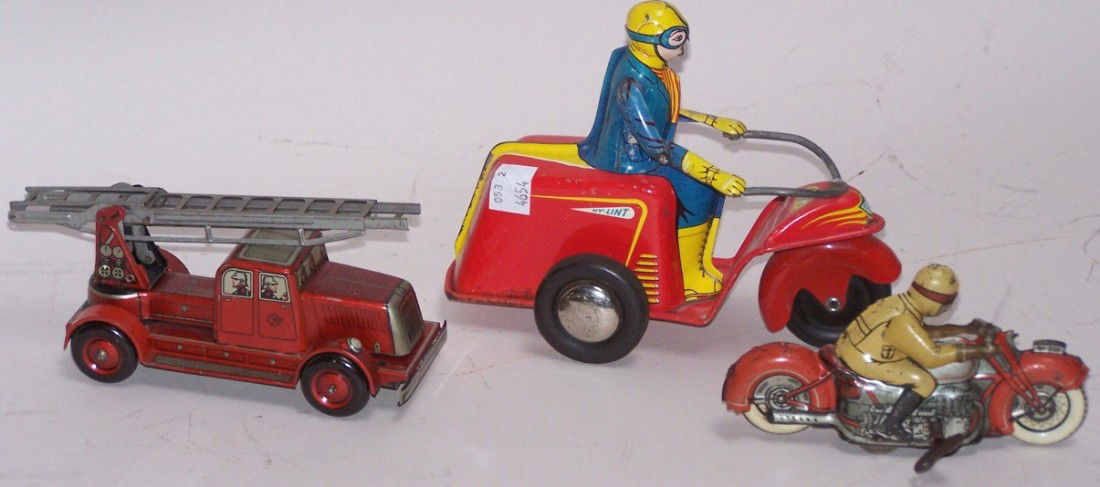***3 TIN WIND UP TOYS: Motorcycle with rider, made by Schuco, approximate length 5'', fire ladder truck marked ''CK'' on door, length 6 1/2'', and Ny-lint three-wheeled motorcycle with rider, length 7''.