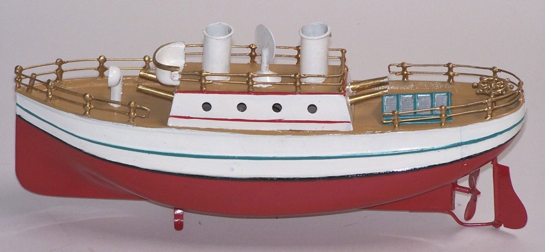 ***TIN WIND UP GUN BOAT: Most likely made by Carette, having twin funnels and permanent wind up key on upper deck, 2 gun barrels facing forward and 2 facing rear, hand soldered railing, single propeller, approximate length 11