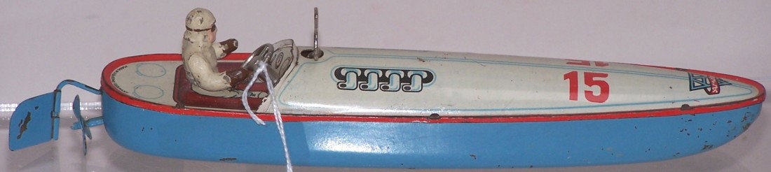***TIN WIND UP TOY SPEED BOAT: Made by Arnold, single propeller and rudder, with tin litho graphics on deck surface, includes single driver figure, steering wheel, and wind up key, marked ''Made in U.S. Zone Germany'' on top of ste