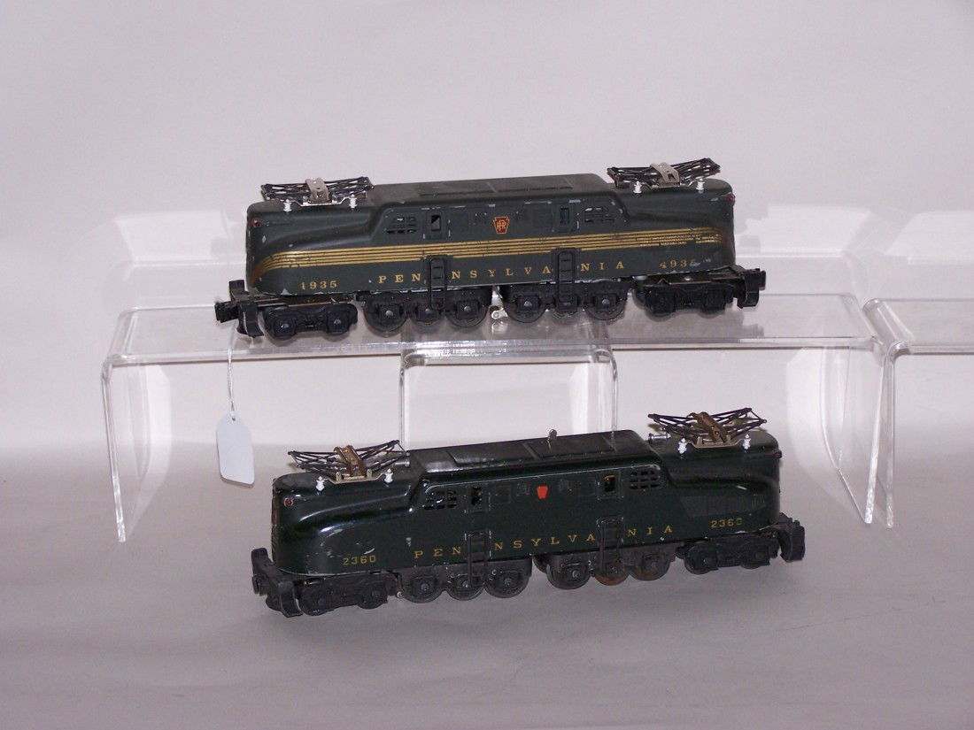 ***2 LIONEL O GAUGE GG1 LOCOMOTIVES: #2360 Pennsylvania and #1935 Pennsylvania with five gold stripes, including cast aluminum shell marked ''25th Anniversary Limited Train Collectors Association.''