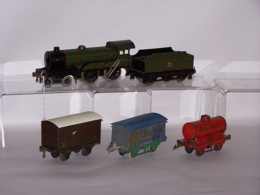 ***BASSETT & LOWKE LOCOMOTIVE AND CARS: Bassett & Lowke wind up O gauge locomotive marked ''Prince Charles'' with #62453 cab, tender marked ''British Railways,'' 1 box car marked ''LMS 12P 91375,'' 1 box car made by Meccano marked ''Cadbury