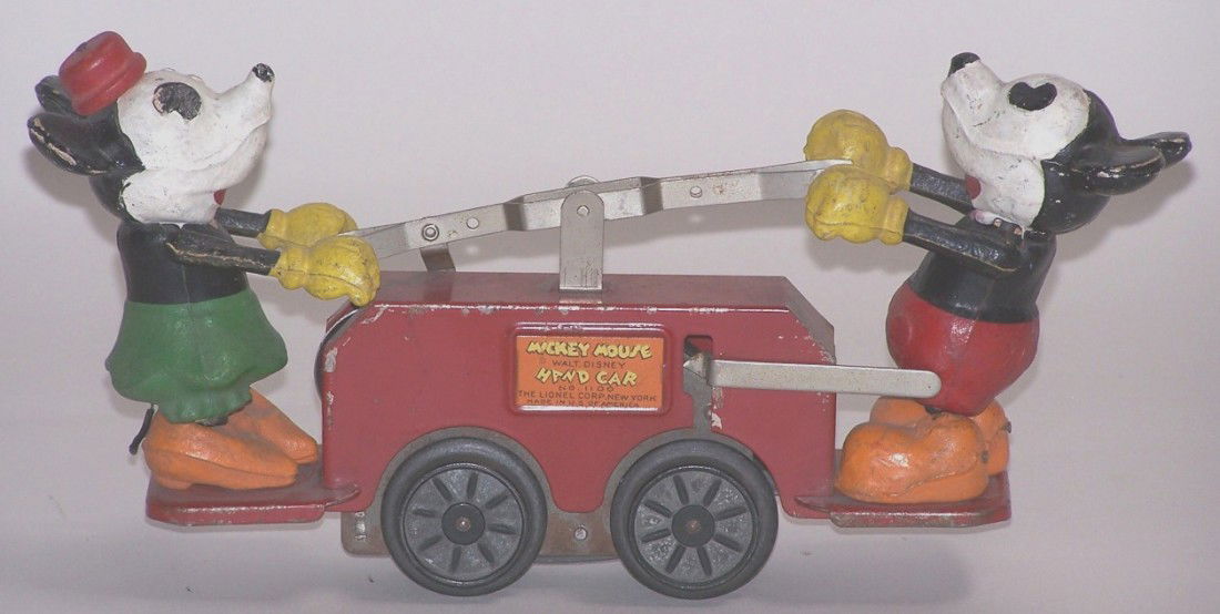 ***LIONEL MICKEY MOUSE WIND UP HAND CAR: With Mickey and Minnie Mouse figures, having flanged wheels for track, approximate length 7''.