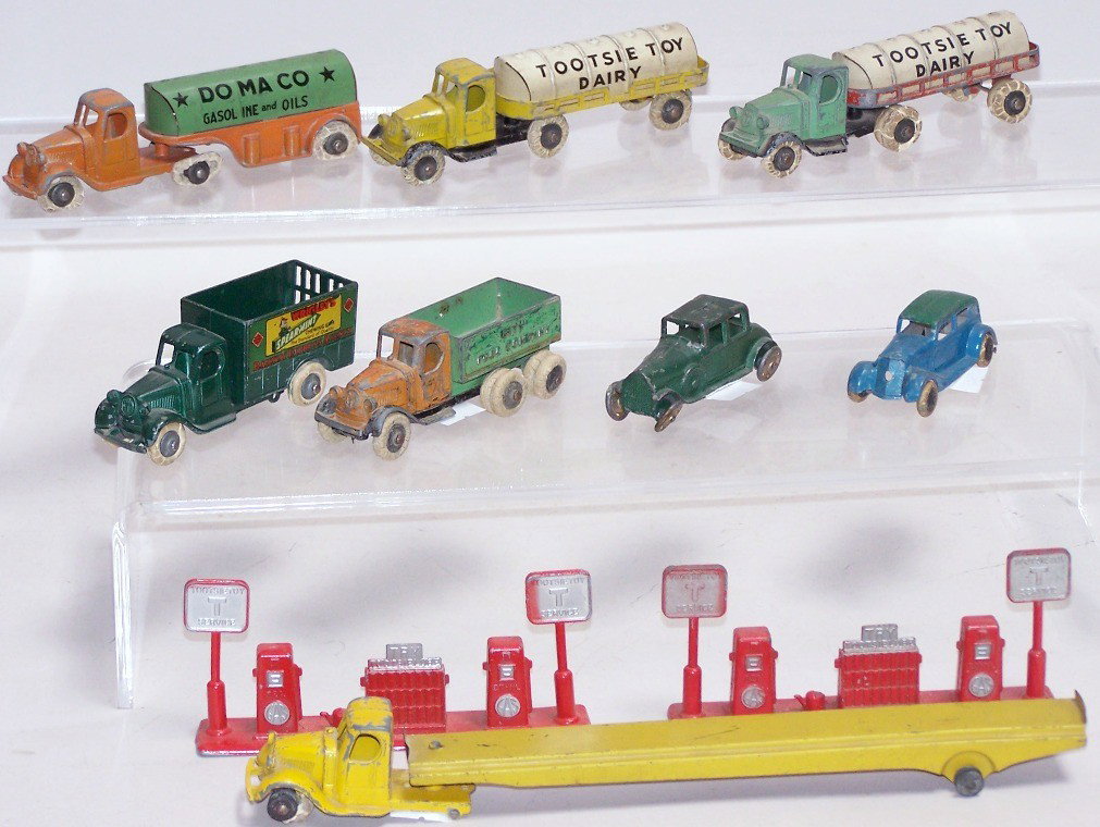 ***11 PRE-WAR TOOTSIE TOYS: Including City Fuel Co. dump truck, Domaco gasoline and oil truck, Mack auto transport tractor and trailer, 4-door sedan, 2-door coupe, Wrigley Spearmint Gum delivery stake truck, 2 Tootsie Toy dairy 