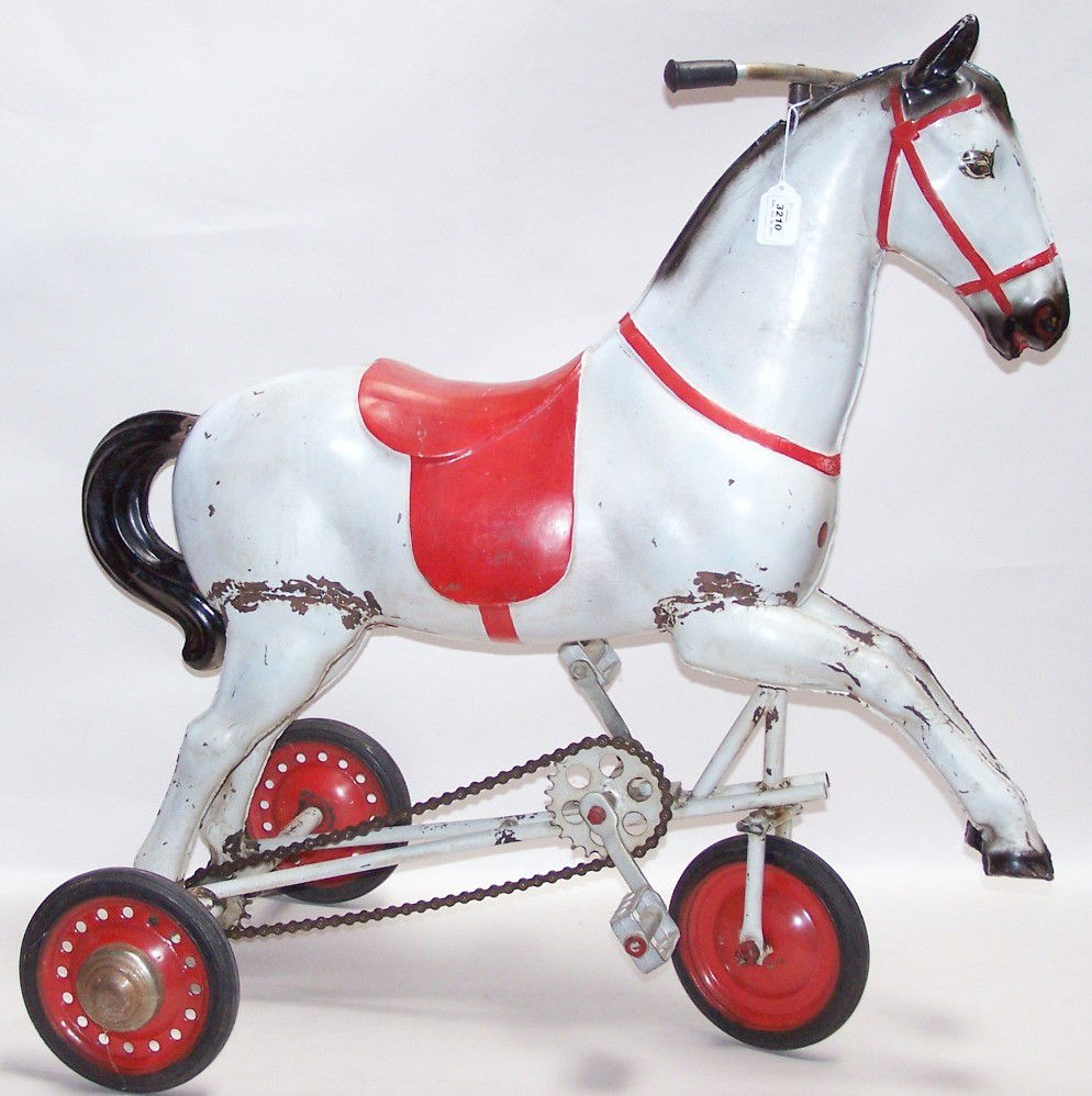 ***VINTAGE FRENCH CHILD'S RIDING TOY: Horse form pedal-powered tricycle, having steel wheels with rubber tires, chain-powered pedal mechanism, and front wheel turned by handlebars, marked ''Made in France'' on front of horse, approximate