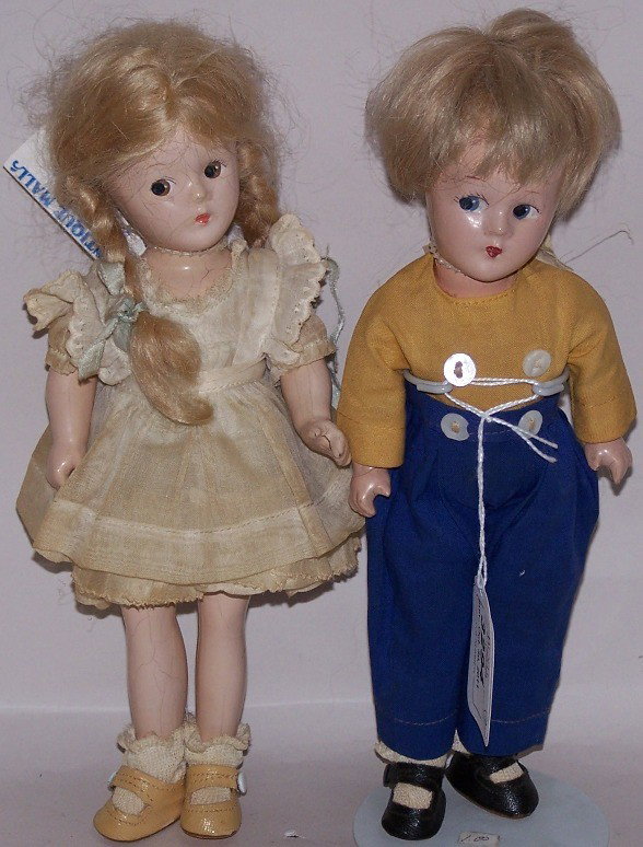***TWO MADAME ALEXANDER COMPOSITION DOLLS: Having painted features, composition bodies, marked on back ''Mme Alexander New York,'' young boy and girl, boy's clothes marked ''Dutch.''
