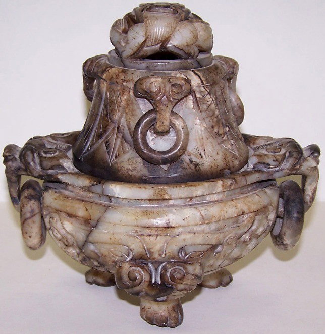***CHINESE GREEN JADE CENSER: Having carved leaf decoration with Foo dog form feet and ringed handles, approximate height 7 1/4''.