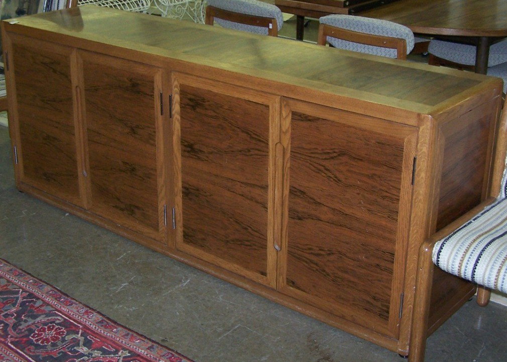 ***DUNBAR OAK AND ROSEWOOD SIDEBOARD: Fitted with 4 doors opening to shelves and drawers, approximate height 30 3/4'', width 78'', depth 19''.