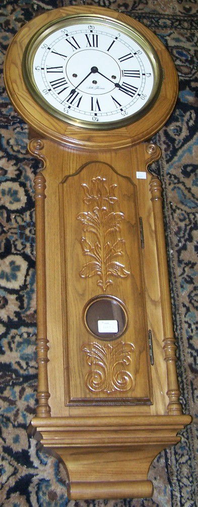 ***VICTORIAN STYLE SETH THOMAS WALL CLOCK: ***VICTORIAN STYLE SETH THOMAS WALL CLOCK| Fitted with time and quarter hour strike movement, metal dial having Roman numeral markers, enclosed in oak case, approximate height 45".