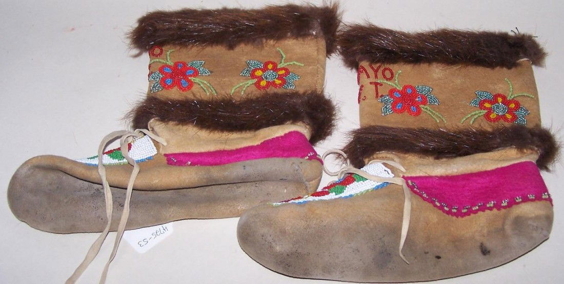 ***BEADED HIDE BOOTS: Beaded with flower, leaf and ''Mayo Y.T.'' design in colors of white, green, blue, yellow red and silver-green, approximate length 11'', height 11''.