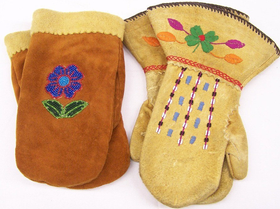 ***TWO PAIR OF MITTENS: One pair with beaded flower and leaf decoration, approximate size 10'' x 5 1/2'', and one pair with beaded and thread design, size 12'' x 8''.