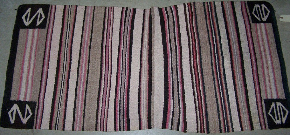 ***NAVAJO WEAVING: Double saddle blanket having band design with colors of black, brown, gray, red and white, approximate size 57 1/2'' x 28 1/2''.
