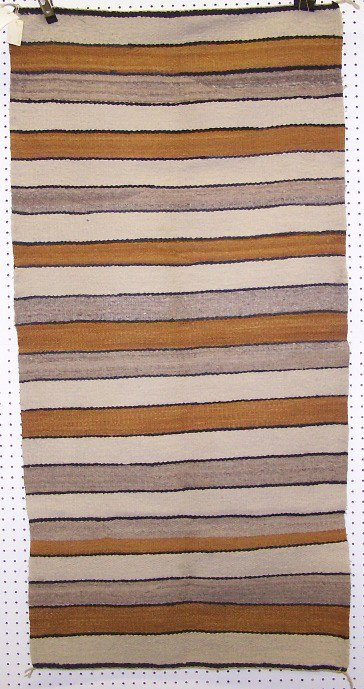 ***NAVAJO DOUBLE SADDLE BLANKET: With stripe design, in colors of black, brown, gray and white, approximate size 62'' x 31''.