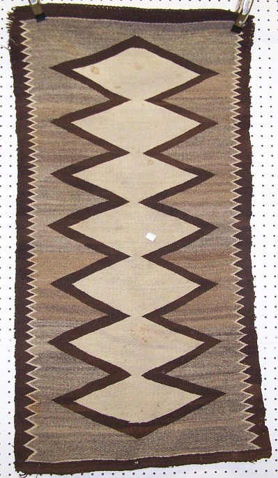 ***NAVAJO WEAVING: With connecting diamond motif in colors of brown, gray and white, approximate size 46'' x 26''.