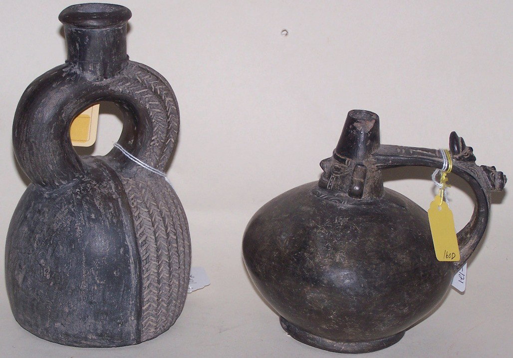 ***TWO BLACKWARE POTTERY VESSELS: One with line decoration, and one with face design, approximate diameter of largest 5'', height 8 1/2''.