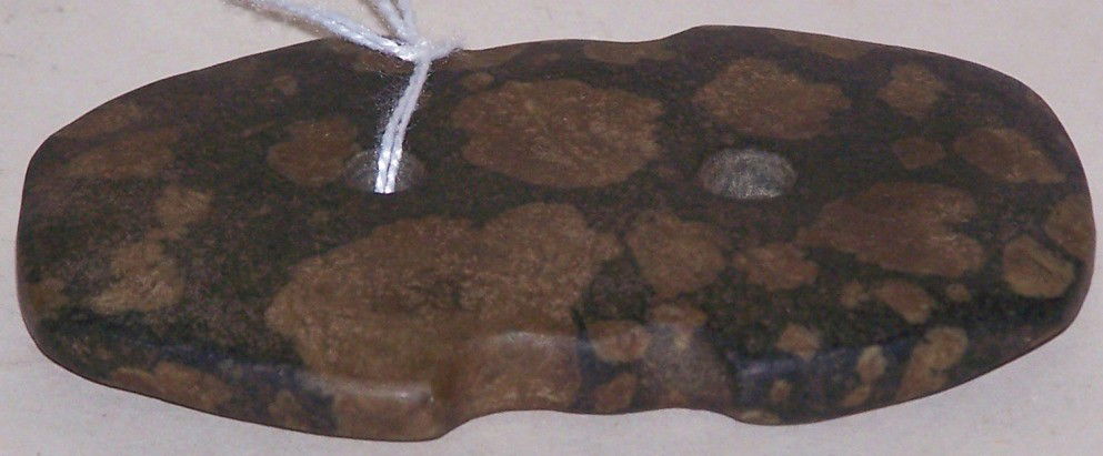 ***GORGET: Two-hole design, black stone with brown inclusions, approximate size 3 1/2'' x 2 1/8'' x 3/8''.