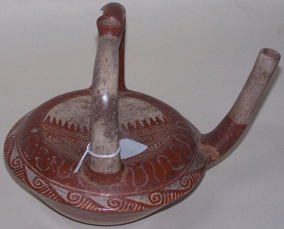 ***STIRRUP-HANDLED POTTERY VESSEL: Redware with painted white decoration, approximate size 7 3/4'' x 7'' x 9''.