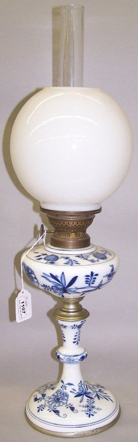 ***MEISSEN PORCELAIN BLUE ONION KEROSENE LAMP: Fitted with brass mounts and milk glass shade and clear glass chimney, metal base marked ''E Beck Mann, Hannover'', approximate lamp height 14 1/4'', overall height 24 1/4''.