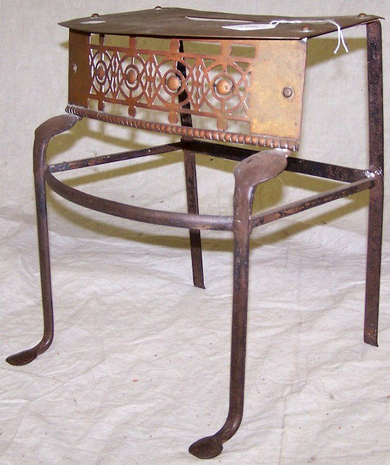 19TH C. BRASS FIREPLACE TRIVET: With engraved decoration depicting pine trees, approximate height 14 3/4'', width 12 1/4'', depth 9 1/2''.