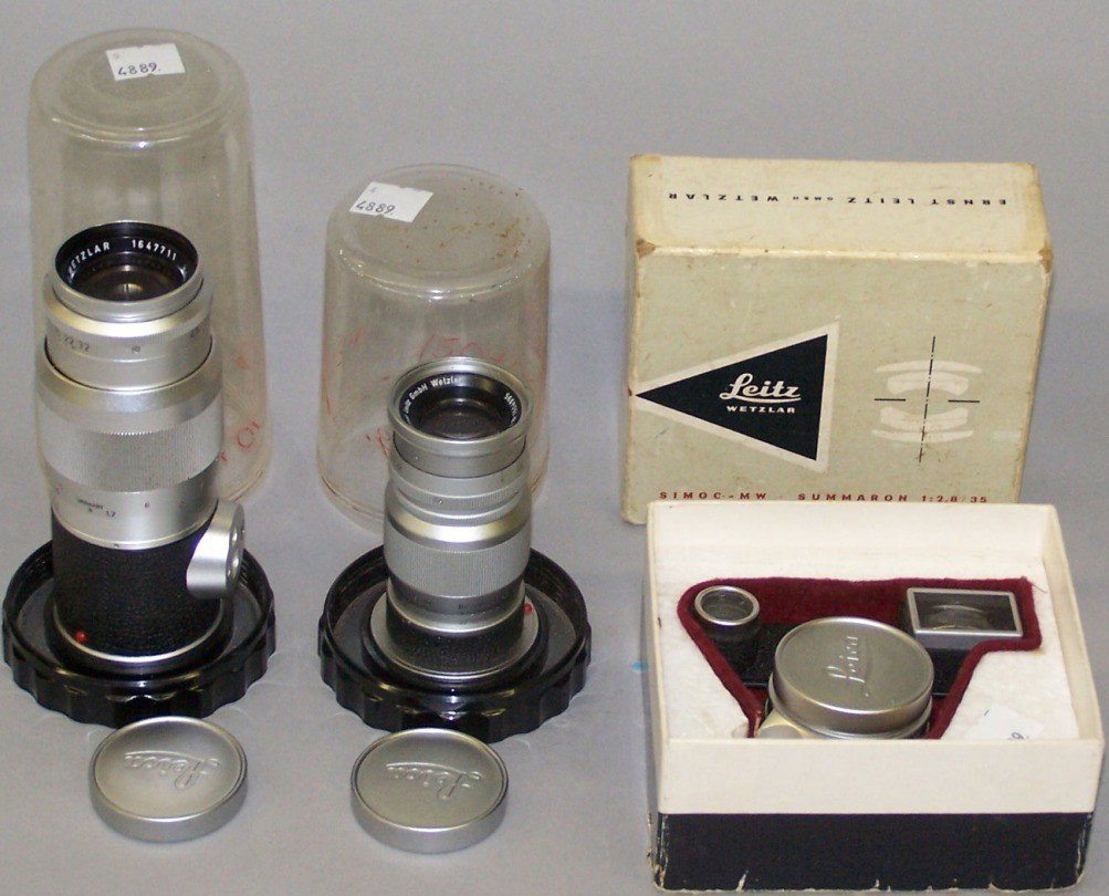 THREE LEICA LENSES: Ernst Leitz GmbH Wetzlar, Elmar f=9cm 1:4 Serial #1504995 and Leitz Wetzlar Serial #1647711 Hektor 1:4.5/135, and a Leitz Wetzlar, SIMOO-MW SUMMARON 1:2.8/35, Serial #1627099, with origanal box.