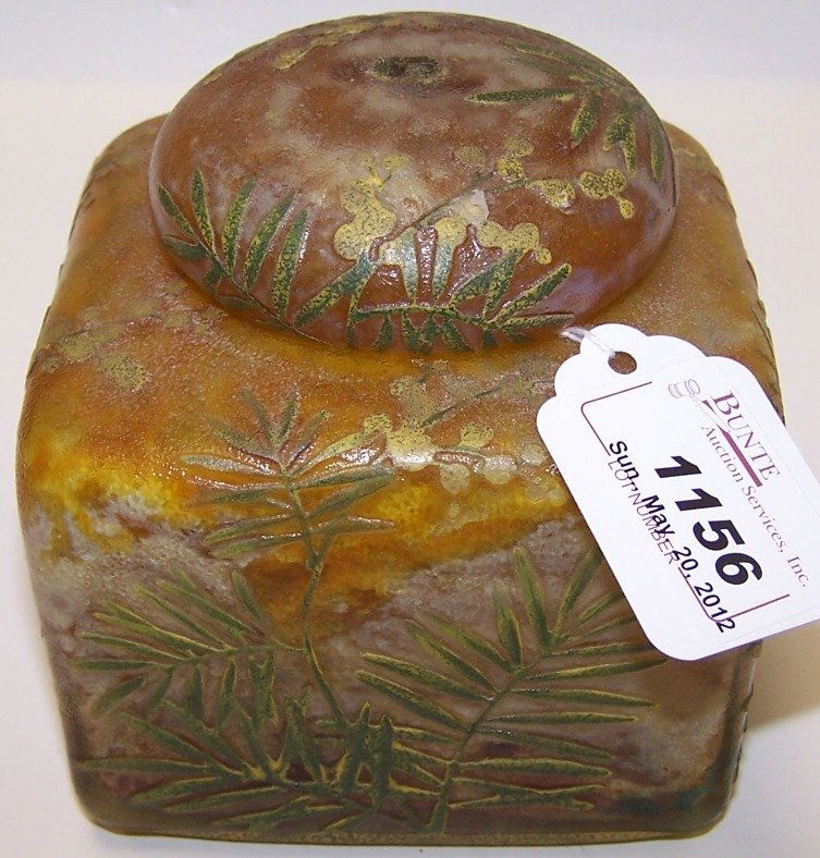 ***DAUM NANCY CAMEO GLASS COVERED BOX: Cut green to mottled orange, with leaf and berry decoration, signed ''Daum Nancy'', approximate height 4'', maximum diameter 5 1/2''.