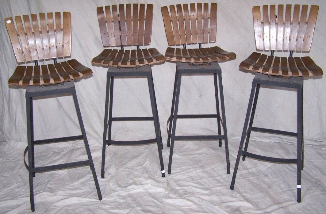 SET OF FOUR ARTHUR OMANOFF BAR STOOLS: Having slat backs and seats and metal bases, approximate height 41'', width 15 1/2'', depth 21''.