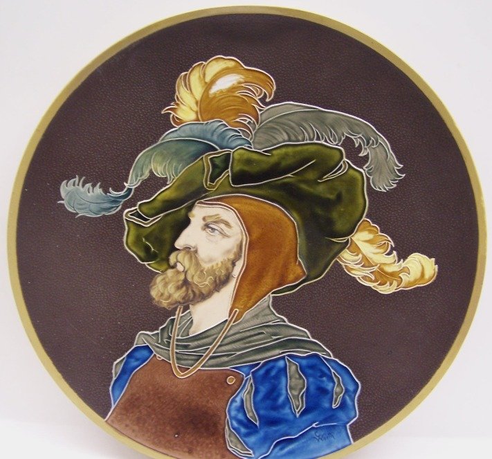 ***METTLACH CHARGER| Decorated with portrait: ***METTLACH CHARGER| Decorated with portrait of medieval bearded man, marked on underside "Mettlach Gesen Nachbildung Geschutz 1168", approximate diameter 16 1/2".