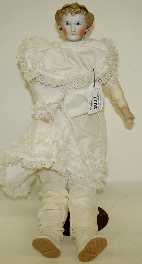 PARIAN WARE COUNTESS DAGMAR HEAD DOLL: Having blue enamel eyes, closed mouth, molded blond hair with tiara, pierced ears with earrings, kid body with hinged cloth lower legs and Parian hands, unmarked, approximate height 16''.