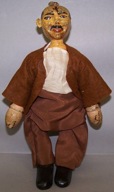 SCHOENHUT WOOD CIRCUS MAN: Tramp/Hobo, having hand painted face, one leather ear, one tack in top of head, chamfered hands opening to side, boat-toed (toe down) black shoes, shirt, brown felt jacket and brown pants, approximate