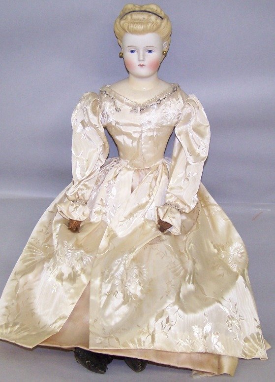 PARIAN WARE HEAD DOLL: Having painted blue eyes, closed mouth, molded and painted blond hair with painted headband, pierced ears with earrings, leather and cloth body, unmarked, approximate height 22''.