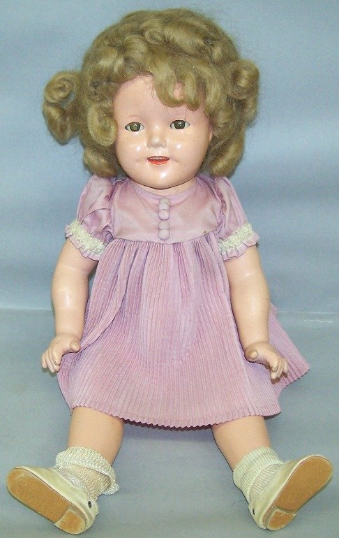 IDEAL COMPOSITION SHIRLEY TEMPLE DOLL: Having sleep eyes, open mouth with teeth, composiiton body, head marked ''Shirley Temple Ideal for Ideal N.T.'', body marked ''Shirley Temple 18'', approximate height 18''.