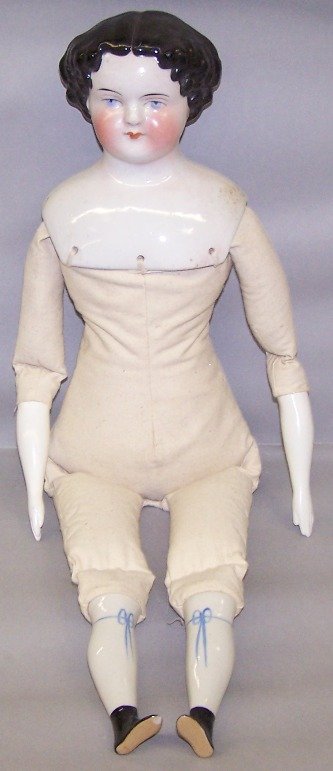 CHINA HEAD DOLL: Having painted blue eyes, closed mouth, flat top style head with molded black hair, cloth body with bisque lower arms, china lower legs with molded black boots, marked ''11'', approximate height 22''.