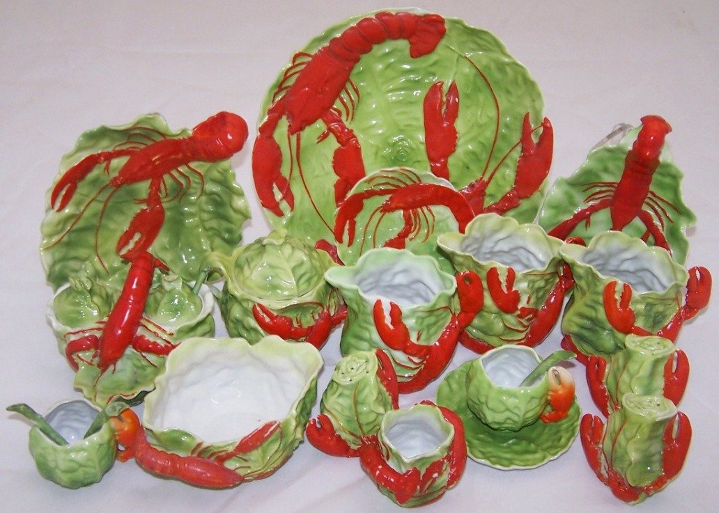 SET OF ROYAL BAYREUTH CHINA: 16 pieces, ''Lobster'' pattern, 3 creamers, covered sugar, small bowl, 2 handled trays, 3 shakers, plate, condiment jar with 2 lids and 1 spoon, small plate, toothpick holder and a demitasse cup and s