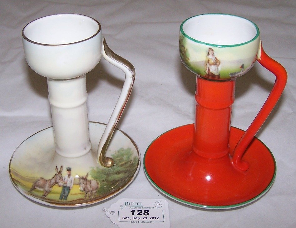 TWO ROYAL BAYREUTH CANDLESTICKS: One decorated with man and donkeys and the other decorated with woman and geese, approximate height 5 1/8''.