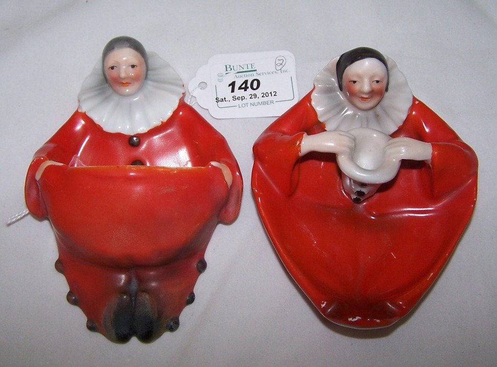 TWO PIECES OF ROYAL BAYREUTH: Hanging match holder and ash receiver, both ''Clown'' pattern, red, approximate length of match holder 5 1/8''.