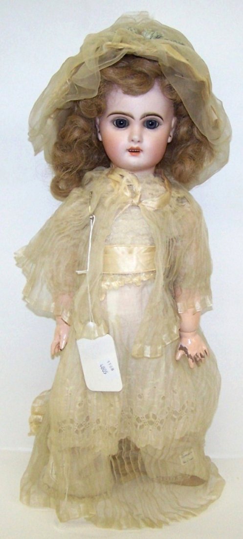 ***ATTRIBUTED TO JUMEAU BISQUE HEAD DOLL: Having set eyes with open mouth and teeth, pierced ears on composition ball jointed body, marked on back ''7'', approximate height 17 1/2''.