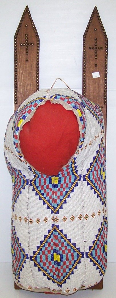 ***CONTEMPORARY BEADED CRADLE BOARD: With large diamond pattern, in colors of blue, yellow, red with white ground, approximate total length 35 1/2''.