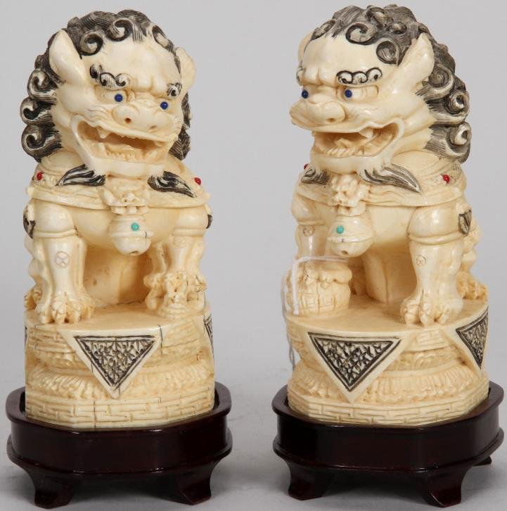 ***PAIR OF CHINESE CARVED IVORY FOO DOGS: Set with semi precious stones, raised on hardwood base, approximate ivory figure height 5''. Note: Items containing ivory will only be shipped domestically and cannot be shipped to California.