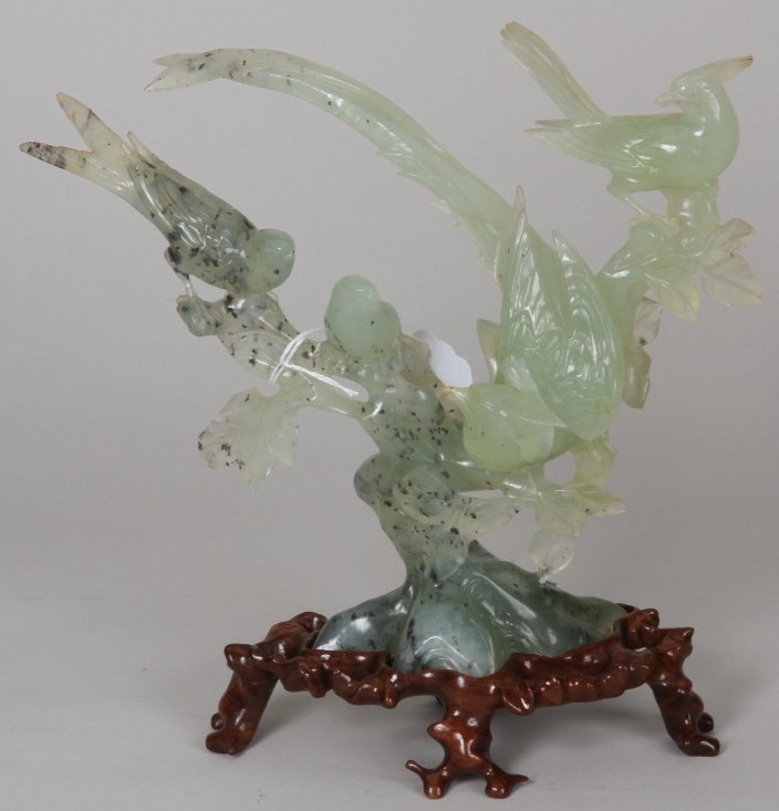 ***CHINESE GREEN HARDSTONE SCULPTURE: Depicting four birds upon flowering branch, raised on a hardwood base, approximate sculpture height 8 1/2''.