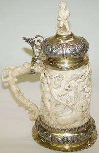 ***GERMAN CARVED IVORY AND SILVER STEIN: Circa 1850, having classical figural decoration, approximate height 11''. Note: Items containing ivory will only be shipped domestically and cannot be shipped to California.