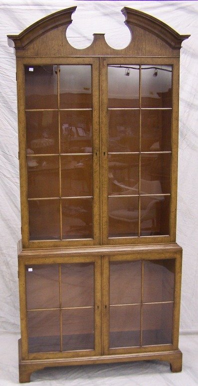 ***QUIGLEY BOOKCASE: Having broken pediment cornice over two glazed paneled doors with two glazed paneled doors below and raised on bracket feet, approximate height 84 1/2'', width 37 3/4'', depth 13''.