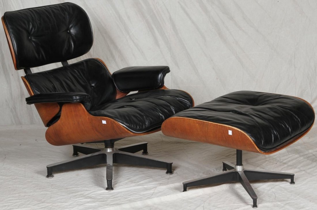 ***HERMAN MILLER EAMES CHAIR: Having black leather upholstery together with matching ottoman, underside of chair bearing metal marker, ''Herman Miller designed by Charles Eames''.