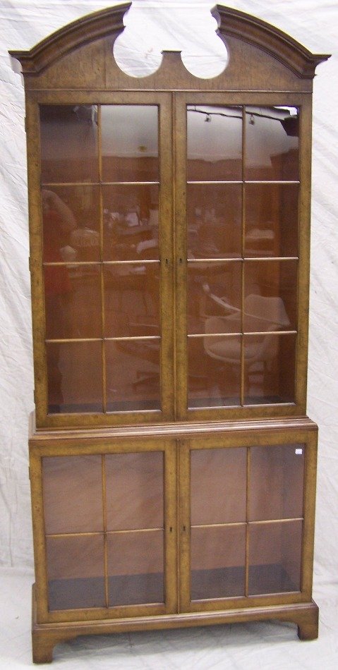 ***QUIGLEY BOOKCASE: Having broken pediment cornice over two glazed paneled doors with two glazed paneled doors below and raised on bracket feet, approximate height 84 1/2", width 37 3/4", depth 13".