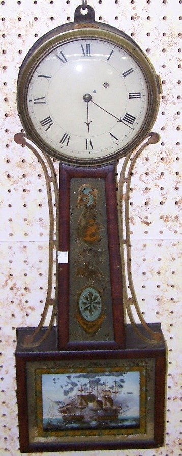***LATE 18TH C. AARON WILLARD BANJO CLOCK: ***LATE 18TH C. AARON WILLARD BANJO CLOCK| Fitted with time only movement, the painted metal dial having Roman numeral markers, enclosed in mahogany case with reverse painting depicting flora and batt