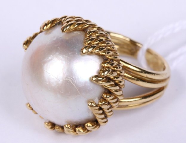 *TIFFANY & CO 18K YELLOW GOLD RING: Set with one mabe pearl, measuring 11.6mm in diameter, approximate ring weight 8.9 dwt.