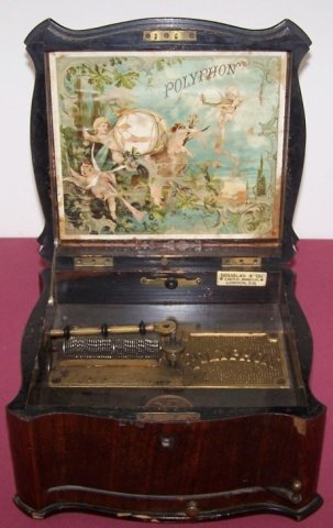 *POLYPHON DISC MUSIC BOX: In walnut case, has polyphon graphic under lid, interior tag marked "Douglas & Co. London, E.C.".