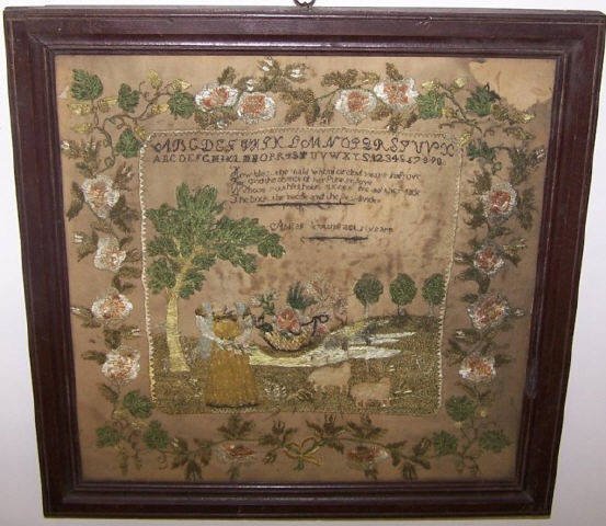 *LATE 18TH/EARLY 19TH C. FOLK ART SAMPLER: Depicting figure in a landscape with sheep, adourned with flowers in a wreath, stitched by a child with an indistinct name that is slightly worn through center, approximately 13 1/2" x 13 1/2", frame 